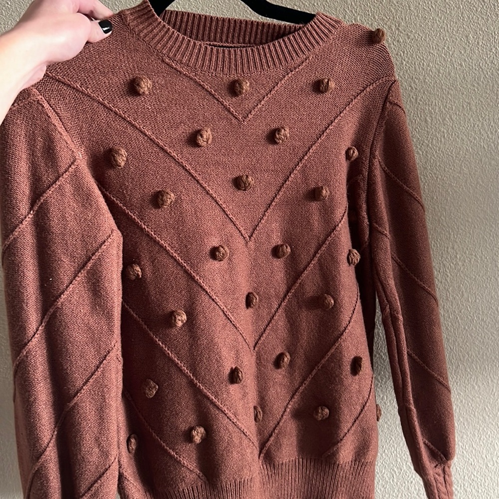 Brown sweater with cute detail.